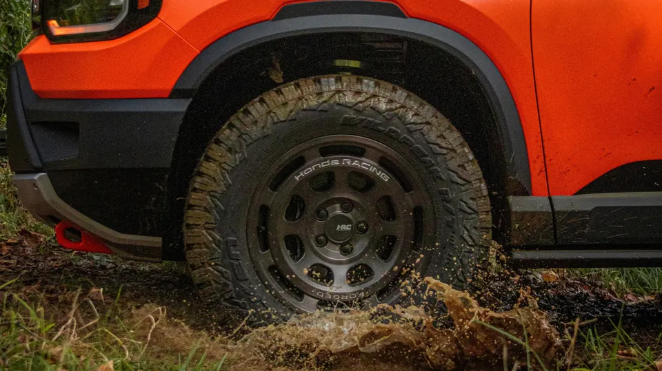 Honda Racing's off-road wheel lineup, shown here kicking up mud, arrives in March alongside a Borla exhaust for the SUVs