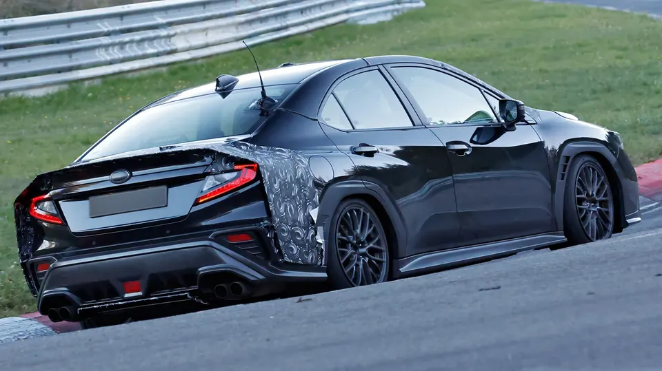 The longtail WRX prototype caught testing, its rear end wrapped in camo and sporting a quad-exhaust diffuser